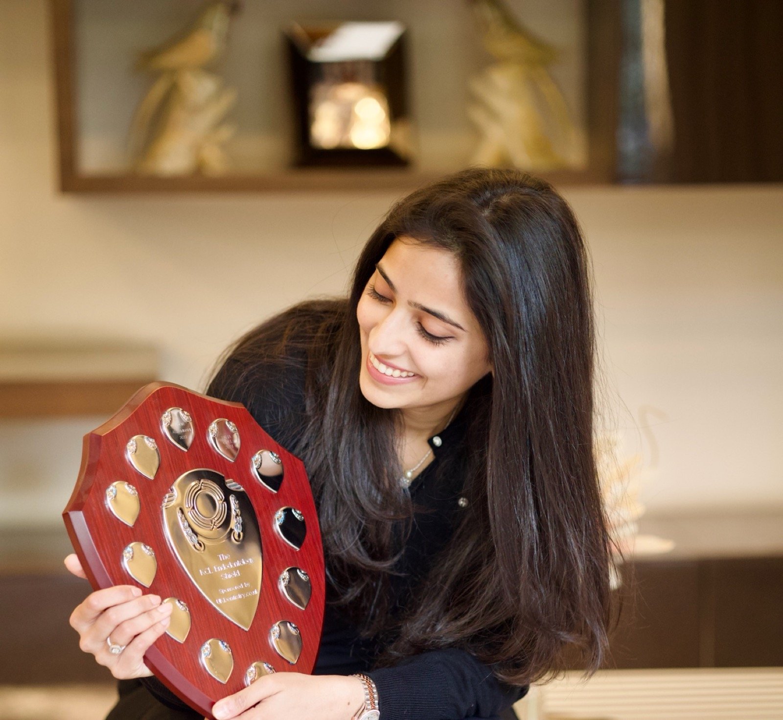 Dr. Esha Goel holding the KCL Endodontology Shield