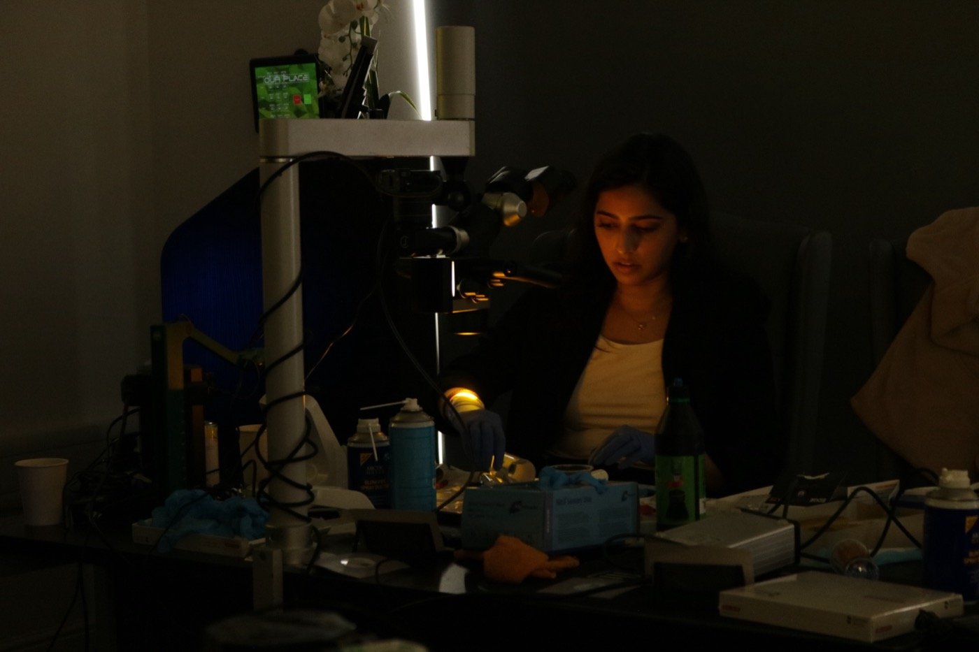 Dr. Goel working late at the operating microscope